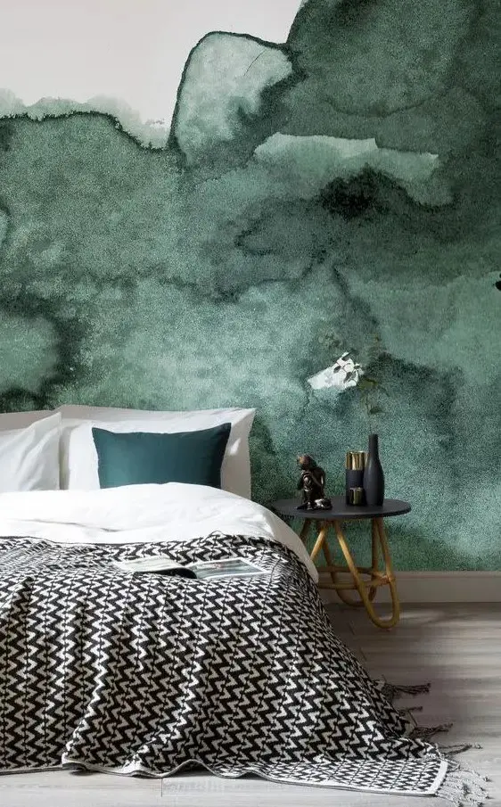 a dark green watercolor accent wall is a great statement in this bedroom, add a matching piece like a pillow here