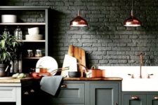 a moody hunter green kitchen with brick walls, stained wooden countertops, copper items for a delicate touch
