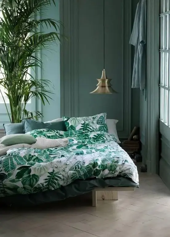 a muted green bedroom and a bright green bedding set with a botanical print for maximal relaxation
