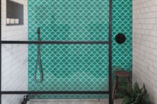 a neutral bathroom with two types of neutral tiles, turquoise fish scale tiles and black touches for a more modern feel