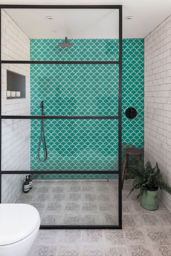 a neutral bathroom with two types of neutral tiles, turquoise fish scale tiles and black touches for a more modern feel