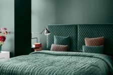 a refined bedroom with matte hunter green walls, a matchin velvet upholstered bed and bedding plus much natural light