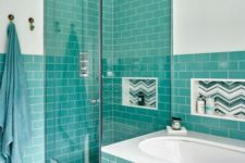 a stylish modern bathroom in white and with turquoise tiles looks contrasting and bright