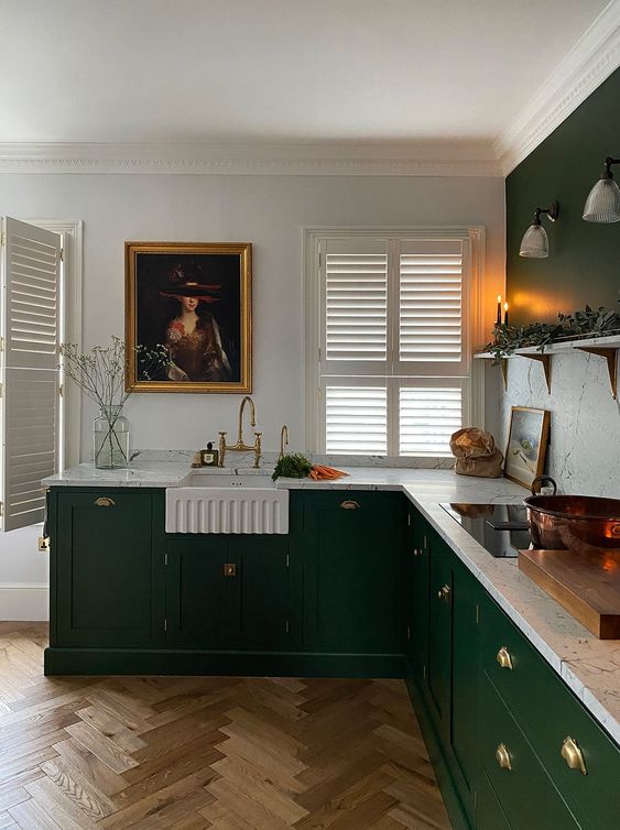 a stylish vintage-inspired kitchen in emerald, with a white marble backsplash and countertops and gold touches