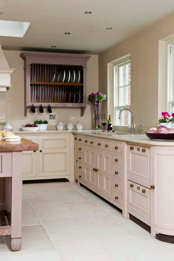 a vintage inspired blush kitchen with lilac cabinets and a lilac kitchen island plus touches of brass is very chic