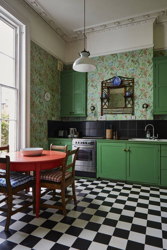 a whimsical retro bright green kitchen with catchy wallpaper walls, a black tile backsplash and a tiled floor