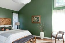 a cute attic bedroom with green walls