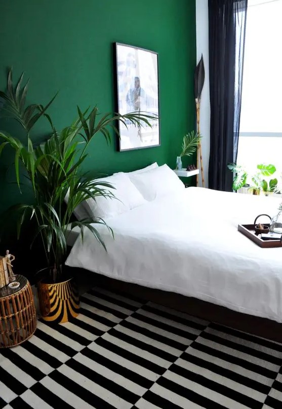 an emerald accent wall will refresh the bedroom and add color to the space