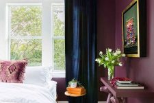08 a modern maximalist bedroom with purple walls, a crazy console table and pillows, navy curtains and a bold artwork