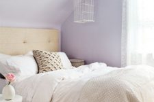 13 a romantic and inspiring lilac bedroom with a tan bed, neutral catchy bedding, a blush floral chandelier and a white nightstand