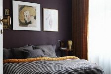 15 a sophisticated moody bedroom with a deep purple accent wall, musard and grey textiles and a stylish gallery wall