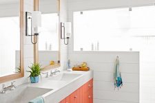 22 a stylish neutral bathroom spruced up with a bright orange double vanity and colorful textiles is super welcoming and cheerful