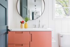 23 a tiny powder room done in a monochromatic color scheme and spruced up with a matte orange vanity with a white sink