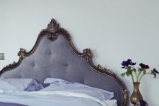 23 a very refined neutral bedroom accented with a lilac bed with a decorated headboard, with lilac and purple bedding and a chic brass vase