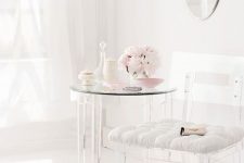24 a lucite chair with a white upholstered seat and a table with lucite legs for a feeling of lightness