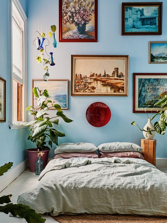 a cute bedroom with a gallery wall above the bed