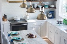 a charming coastal kitchen with white cabients, an aqua scale tile backsplash, a marble kitchen island and blue striped chairs