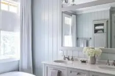a bathroom with a shiplap accent wall