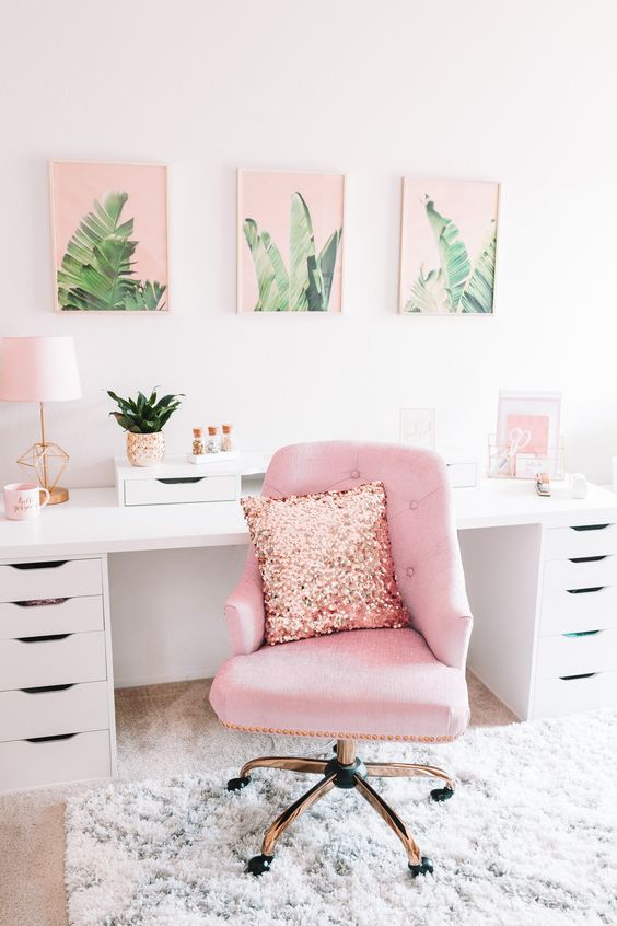 a glam tropical girlish home office in white infused with pink - a pink gallery wall, chair and accessories on the desk
