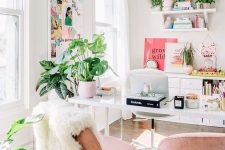 a glam tropical-infused home office with blush chairs, potted greenery, pink accessories and a ffun moodboard
