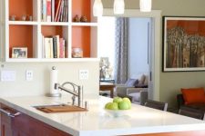 a modern burnt orange kitchen with white stone countertops and a matching open shelving unit plus pendant lamps