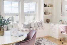a neutral and a bit pastel home office with printed textiles, lavender chairs, a comfy windowsill bench and gold touches