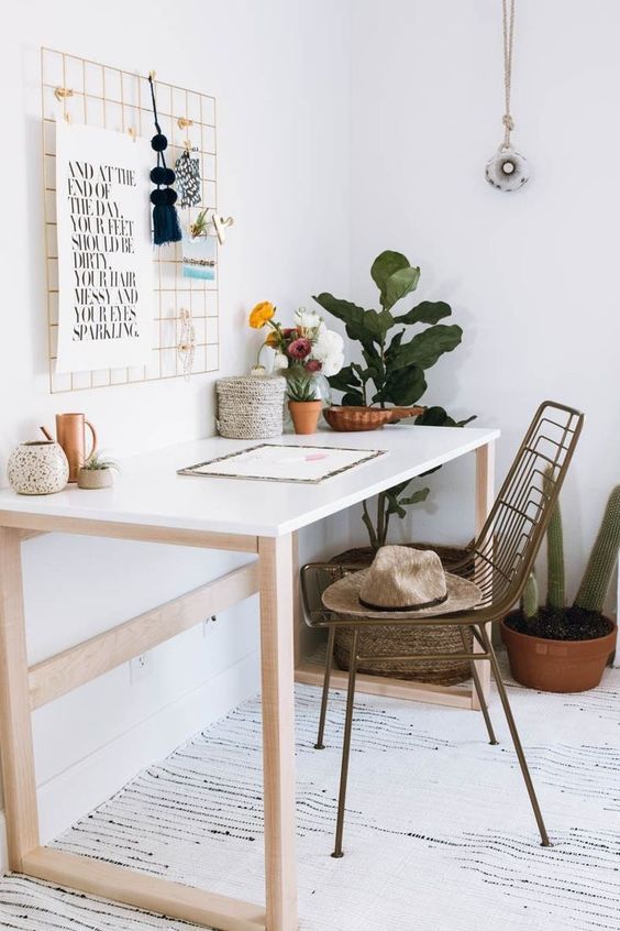 a neutral boho home office with a simple table, a woven chair, potted plants and cacti, a grid with various ideas