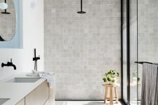 a cool neutral bathroom design with black touches