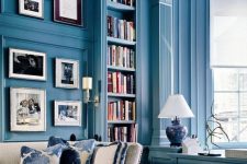 a refined vintage blue living room with light blue walls, molding, neutral furniture and large windows