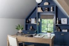 a small attic home office in neutrals, with a blue storage unit that takes a wall, simple neutral furniture