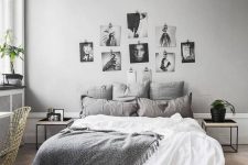 a stylish Nordic bedroom with dove grey walls, grey and white bedding, a gallery wall and touches of black