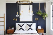 a stylish boho chic bedroom with a navy wall, stylish mid-century modern furniture, touches of gold and potted plants