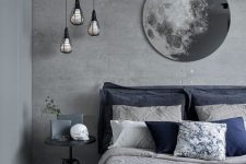 a stylish grey bedroom with concrete walls and a storage unit, a grey bed with grey and navy bedding, a grey side table and a gorgeous moon artwork