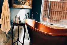 refined 19th century aesthetics with a gorgeous artwork, marble and a copper tub in front of the window