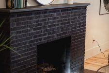 02 an elegant black brick fireplace with matching black hex tiles in front of it is a cool decor feature for any space