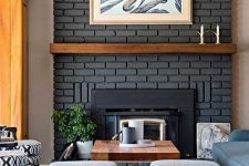 10 a black faux brick fireplace with a wooden mantel and some artworks around for a stylish and elegant look