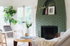 22 a green brick fireplace with a niche for art looks out of the box and adds color to this neutral living room