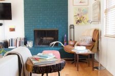 26 a teal brick fireplace, even a non-working one, is a very non-traditional decor feature to go for
