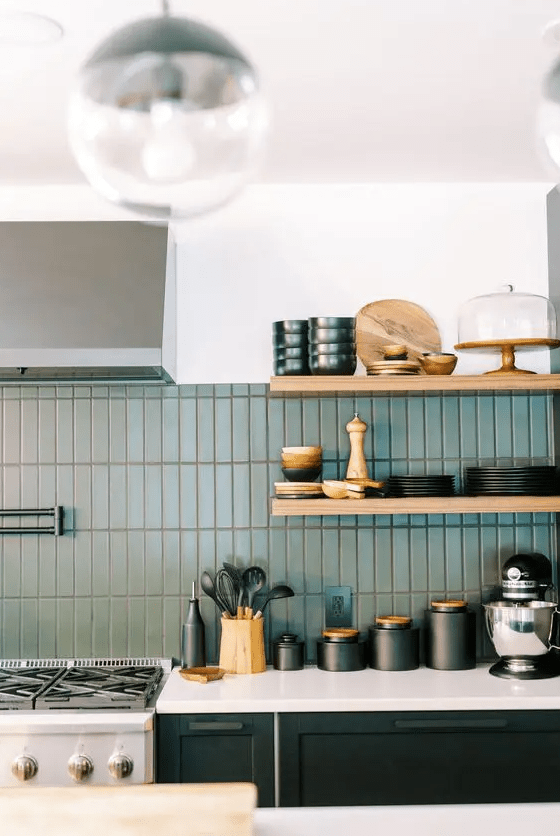 a stylish b&w kitchen with a creative backsplash