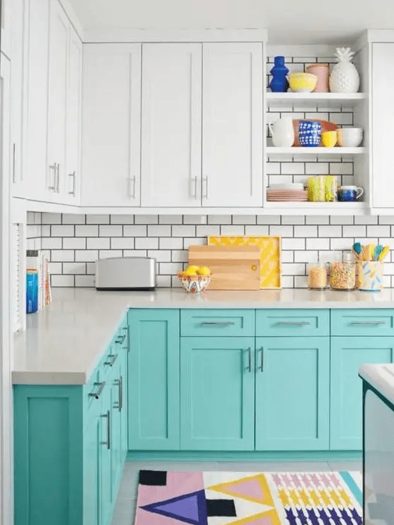 a cheerful turquoise and white kitchen with white subway tiles, colorful accessories and rugs for a fun feel