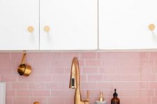 a chic neutral kitchen with a pink subway tile backsplash and touches of gold for a glam and cute look