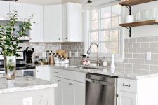 a chic white farmhouse kitchen with terrazzo countertops and a grey subway tile backsplash is very elegant