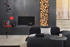 a contemporary monochromatic interior finished with a faux fireplace clad with metal sheets and with a firewood storage niche