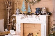 a faux fireplace with logs and lights, with Christmas decor on the mantel and around it is a gorgeous idea