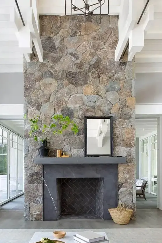 a large fireplace clad with beautiful stone and decorated with greenery will be a show-stopper in your room