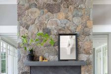 a large stone fireplace with the fireplace itself clad with grey marble is a bold farmhouse piece that brings coziness