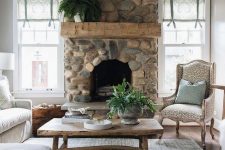 a refined vintage living room with a river rock fireplace that brings a touch of nature to the space