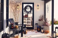 a rustic Halloween porch with lots of leaves, natural pumpkins, wooden black pumpkin lanterns and dried and fresh plants