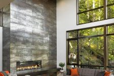 a shiny sleek metal fireplace that takes a whole wall will become a centerpiece of any living room and make it bolder