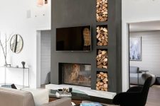 a stylish contemporary living room with a graphite grey concrete fireplace and niches for storage plus chic and stylish furniture